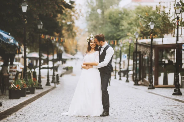 Handsome loving couple newlyweds gently embrace,  romantic wedding moment