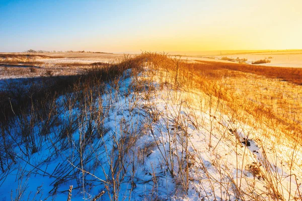 A beautifulsunset on snowing hills, colorful sunset on snowing field