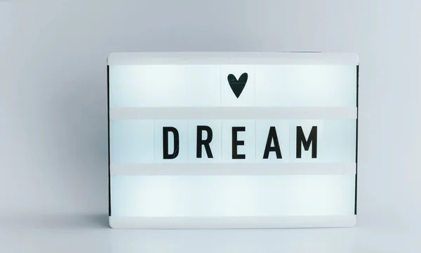 Photo of a light box with text, DREAM, isolated white background