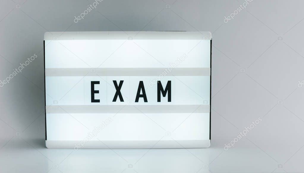 Light box with the headline EXAM with copyspace, over white background 