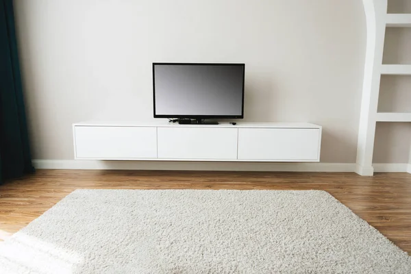 Beautiful and clean living room with Smart TV and blank screen
