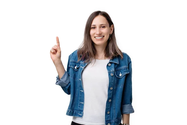 Portrait of happy young woman pointing up over white background — Stock Photo, Image
