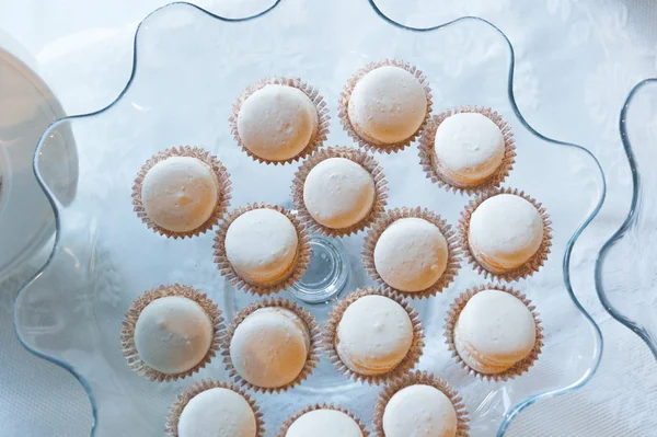 Savoureux mini gâteaux blancs sur une plaque incurvée en verre. Vue du dessus . — Photo