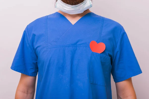 Photo of doctor surgeon with red heart shape over chest