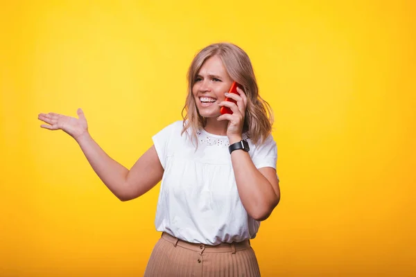 Foto de uma jovem falando ao telefone e gesticulando — Fotografia de Stock