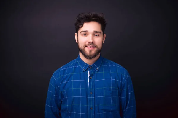 Portrait of handsome man in blue shirt over black background — Stok Foto