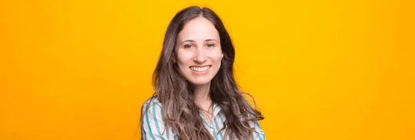 Sarı Arka Planda Gülümseyen Genç Bir Kadının Fotoğrafını Çek — Stok fotoğraf