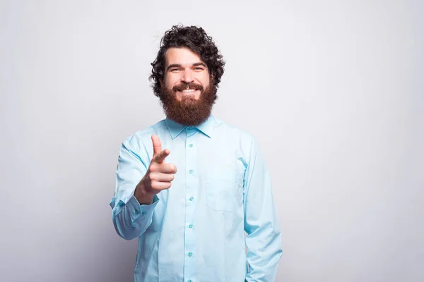Foto van vrolijke bebaarde man in blauw shirt wijzend naar de kwam — Stockfoto