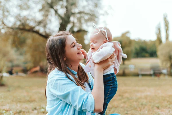 Portrait of cheerful young mother having time with her baby girl outdoors — Stock Photo, Image