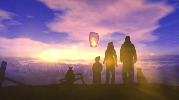 Eine Familie auf einem Winterspaziergang stellt eine chinesische Laterne auf — Stockvideo