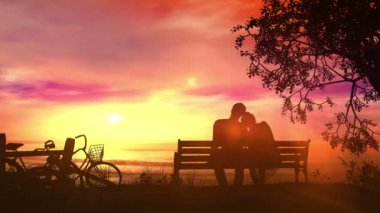 Bir bisiklet yolculuğu sonra okyanus izlerken bir bankta çift