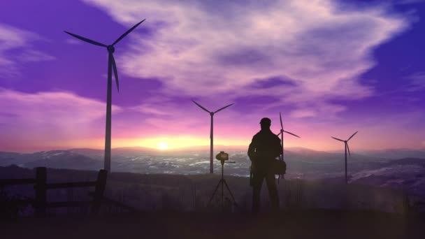 Silhouettes of wind power plants towering against sunset. — Stock Video