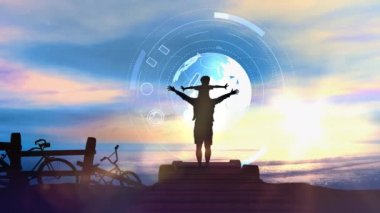 Deniz günbatımının arka planında babayla oğlunun siluetleri..