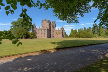 View of Glamis Castle in Scotland. Glamis Castle is situated close to the village of Glamis in Angus. It is the home of the Earl and Countess of Strathmore and Kinghorne, and is open to the public. clipart