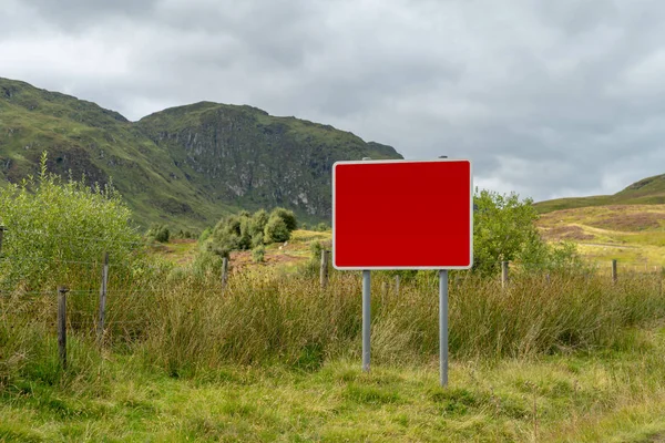 Blank winter weather warning sign on minor road in Ben Lawers mountain range in Perthshire in Scottish highlands.