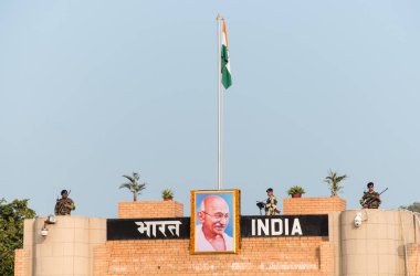 WAGAH, INDIA - NOVEMBER 26, 2015: Indian guards at the ceremonial flag lowering on India-Pakistan border at Wagah, Amritsar, Punjab, India, Asia. clipart