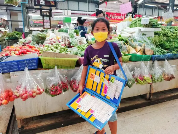 Koruyucu maske takan, piyango bileti satan küçük bir kız 22 Ağustos 2022 'de Tayland, Pathumthani' de bir süpermarkette kaçırıldı..