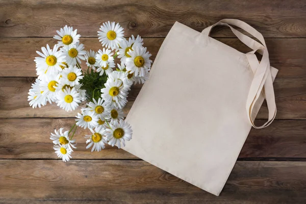 Rustic tote bag mockup with daisy