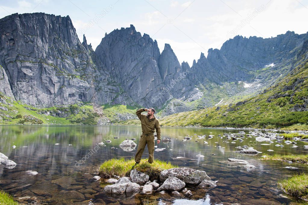 Travelers in the mountains Duse Alin Russian Far East Khabarovsk region. Guy on mountain lake by the name of the Bear Ridge Duse Alin Russian Far East Khabarovsk region.