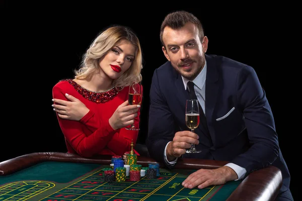 Beautiful and well dressed couple playing roulette in the casino — Stock Photo, Image
