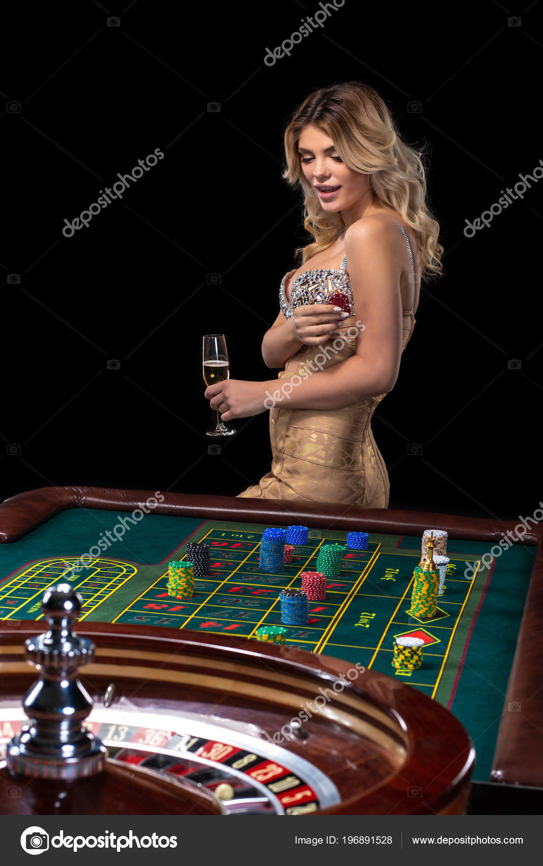 Young blonde woman wearing beautiful sexy shiny dress is playing roulette  in the casino Stock Photo by ©nazarov.dnepr@gmail.com 196891528
