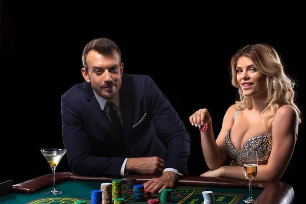 Pareja de apuestas en la mesa de ruleta en el casino — Foto de Stock