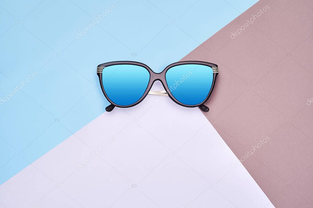 Minimal style. Minimalist Fashion photography. Fashion summer is coming concept. Sunglasses on a colorful background
