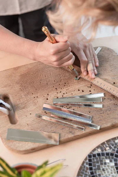 İşyeri mozaik ustası: aracı bir mozaik yapım sürecinde mozaik Ayrıntılar için holding kadın eller. Yakın çekim. Yaratıcı süreç. Masterclass el yapımı