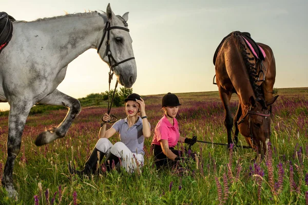 Two woman and two horses outdoor in summer happy sunset together nature — Stock Photo, Image