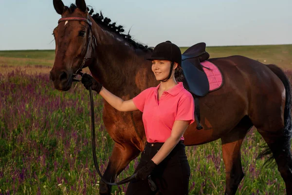 Beautiful young girl smile at her horse dressing uniform competition: outdoors portrait on sunset — Stock Photo, Image