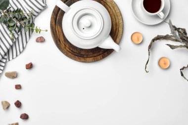 Bir tabloda çay ile beyaz porselen demlik bir ahşap tahta ve beyaz bir fincan. Üstten görünüm. Kopya alanı.