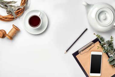 Kalem ve beyaz tabloda çay ile not etmek. Çalışma alanı. El yapımı. Üstten görünüm, düz yatıyordu.