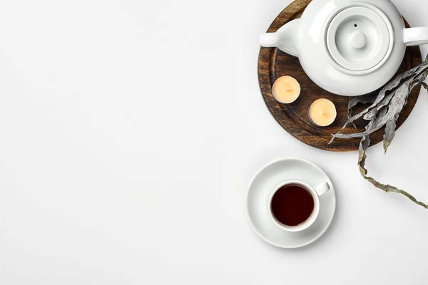 Top view of the tea pot and tea cup on white background