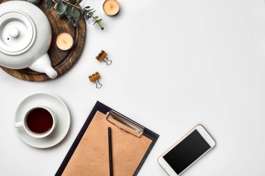 Kraft kağıt, cep telefonu, siyah çay, kopya alanı beyaz zemin üzerine gözlük ile defter.