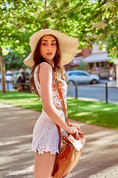 Estilo de vida ensolarado retrato de moda de jovem elegante mulher hipster andando na rua, vestindo roupa da moda, chapéu de palha, viajar com mochila . — Fotografia de Stock