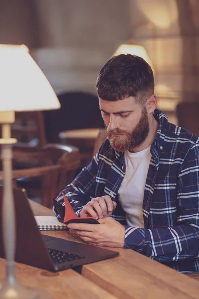 Casual business man or freelancer planning his work on notebook,