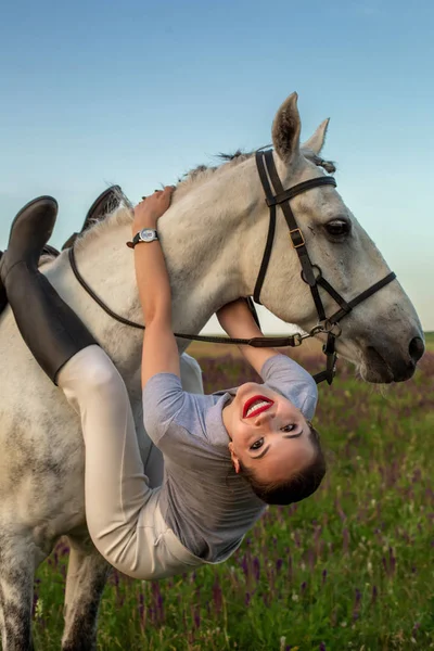 Beautiful young girl smile at her horse dressing uniform competition: outdoors portrait on sunset — Stock Photo, Image
