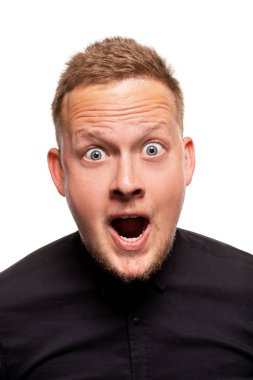 Vertical shot of stupefied stunned shocked young male keeps mouth widely opened, being surprised and very emotional, expresses great surprisment. clipart