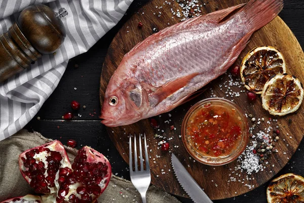 Delicious fresh raw red seafood fish mullet on wooden cutting board, top view — Stock Photo, Image