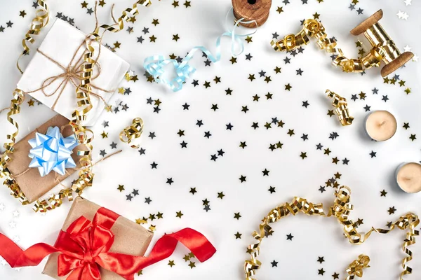 精致的波浪色丝带和金属星状的五彩纸屑在白色背景上被隔离。圣诞假期装饰理念. — 图库照片