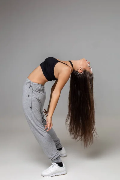 Modern dancer poses in front of the gray studio background — Stock Photo, Image