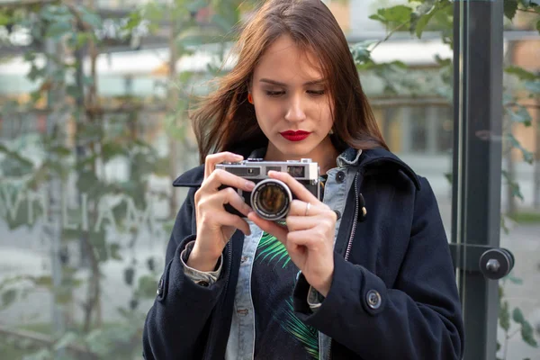 Utomhus höst leende livsstil porträtt av ganska ung kvinna, roar sig i staden med kamera, resa foto av fotograf. — Stockfoto