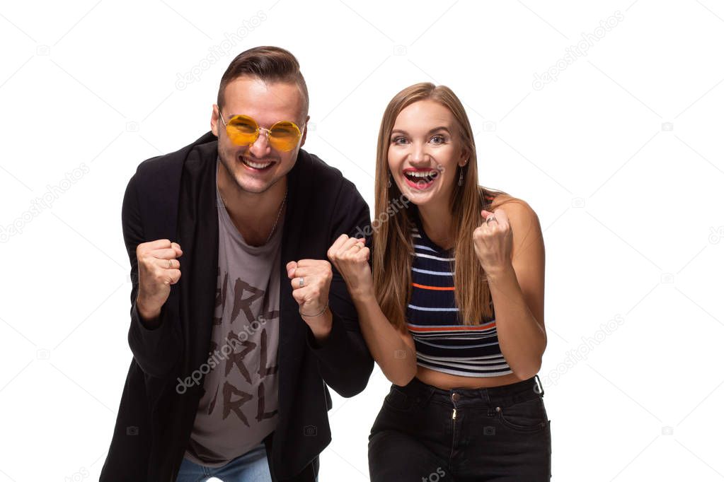Overjoyed woman and man raise fists with triumph, have successful deal, exclaim joyfully, isolated over white background.