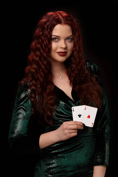 Sexy rousse femme posant avec une carte à jouer dans ses mains, sur fond noir — Photo