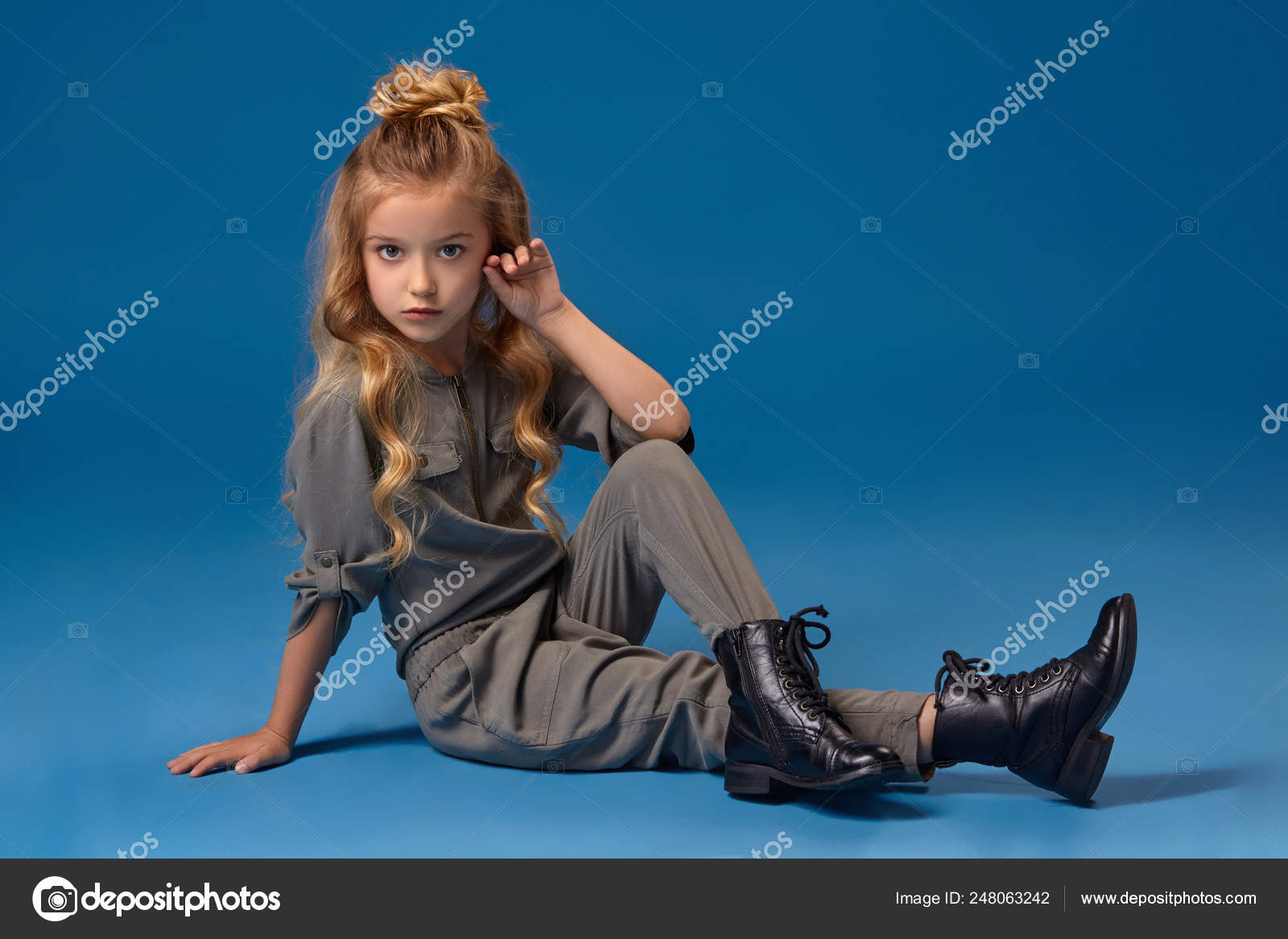 Little girl with a long curly hair in a fashionable clothes Stock Photo ...
