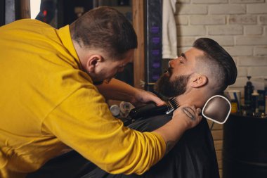 İstemci kuaför dükkanı sakal tıraş sırasında büyük siyah sakallı