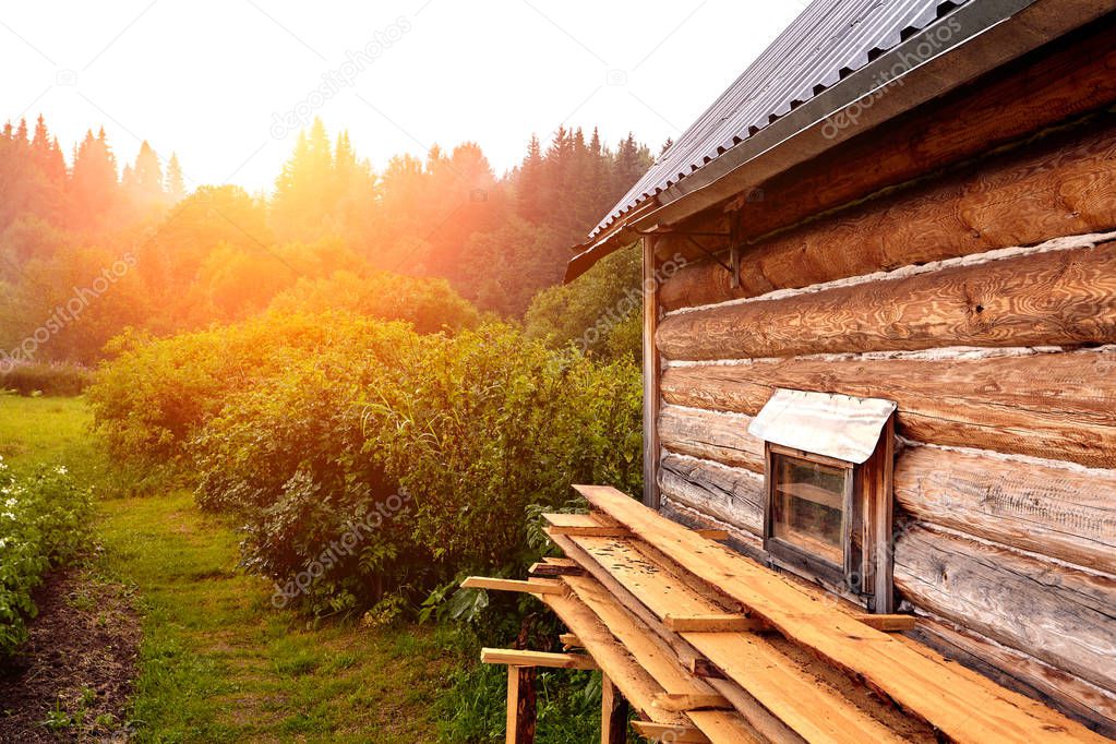 Front view of wooden house in russian village in sunny summer day