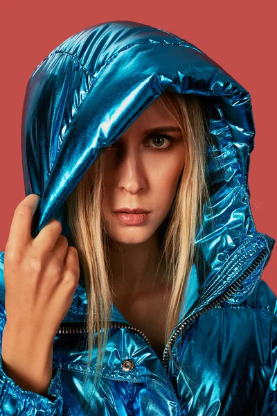 Sarışın ince kız mavi ceket aşağı kukuleta ile rüzgar yüzünden kapsar — Stok fotoğraf