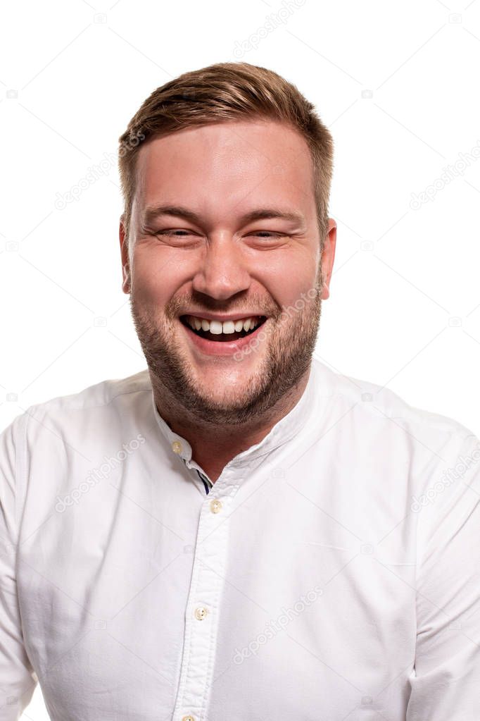 Close up horizontal portrait of a handsome man with a beard, stylish haircut, wearing a white shirt, isolated on a white background