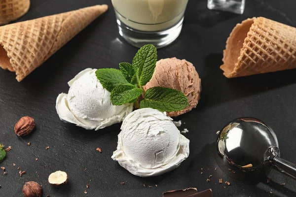Gourmet creamy and chocolate ice cream served on a stone slate over a black background. — Stock Photo, Image